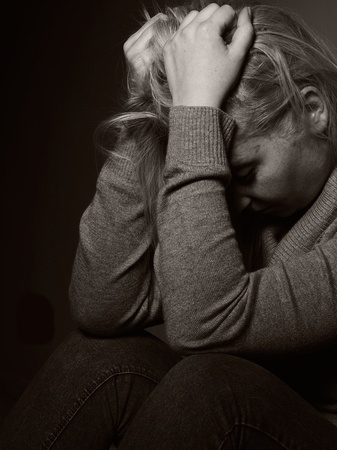 Woman in crisis with hands in hair